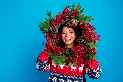 Photo of cheerful funky girl wear stylish ornament sweater holly jolly good mood xmas preparation isolated on blue color background.