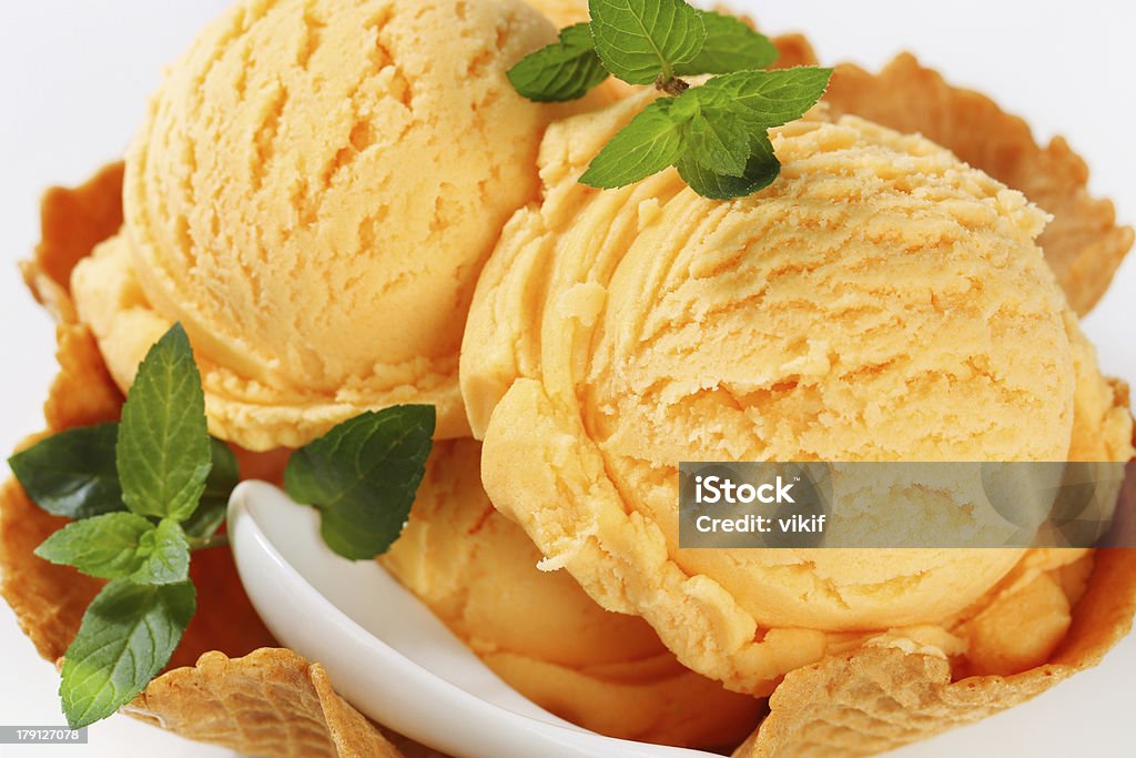 Orange sherbet in a waffle basket Scoops of ice cream in a waffle basket Peach Ice Cream Stock Photo