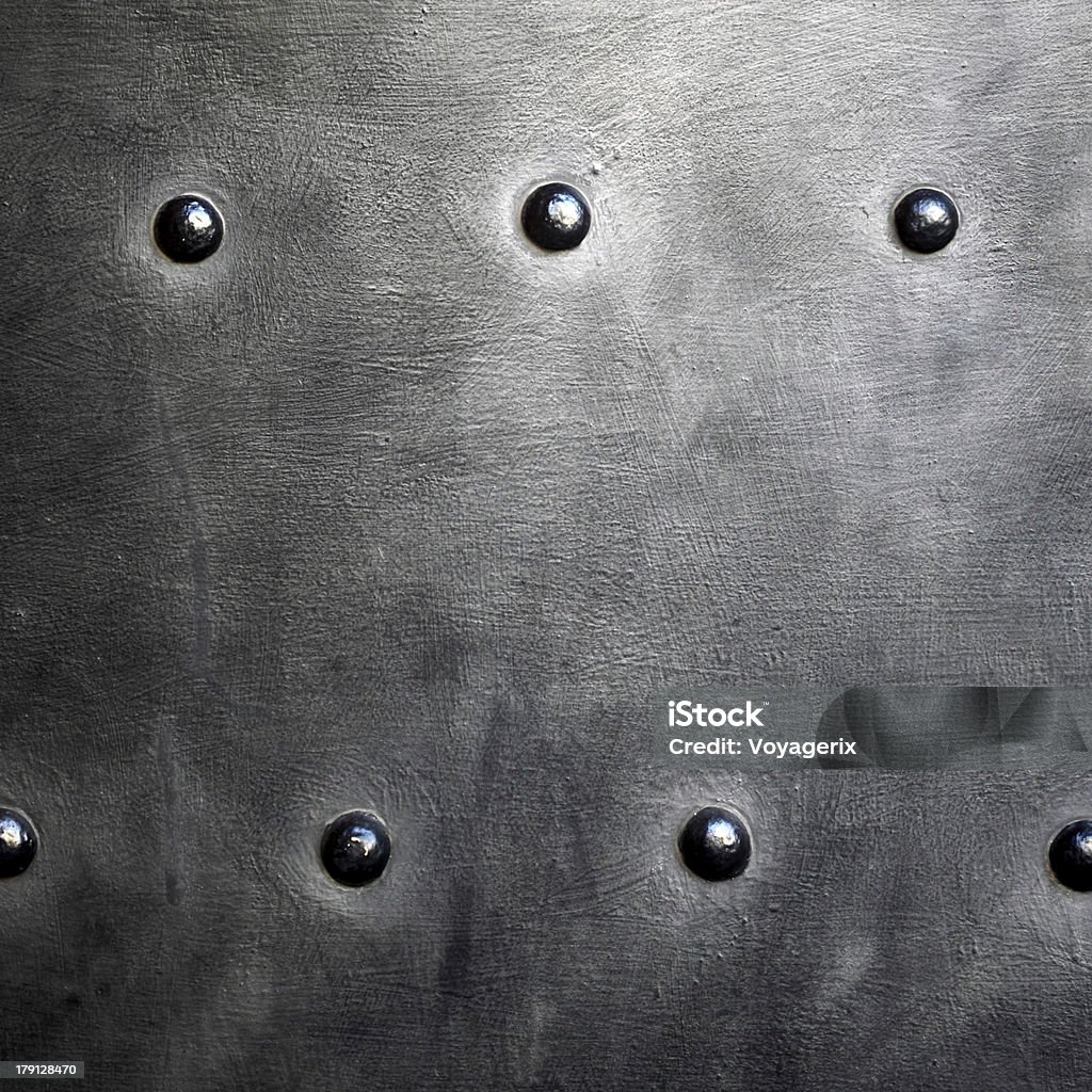 Black metal plate or armour texture with rivets Black grunge metal plate or armour texture with rivets as background Black Color Stock Photo
