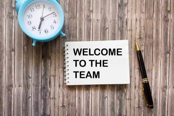 istock WELCOME TO THE TEAM text concept written on notepad with clock and pen on wooden background 1791287745