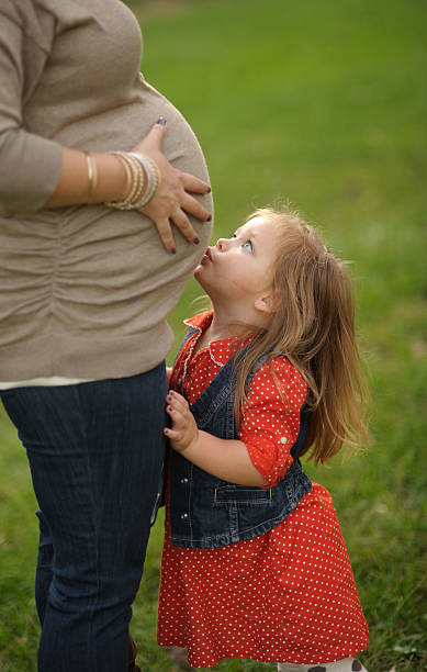istock Daughter Kissing Mommy's Belly 179128844