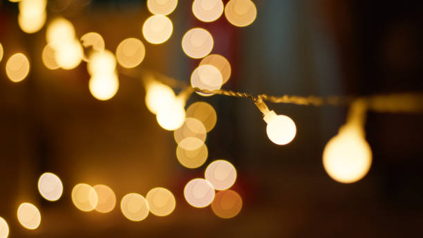 istock Shiny christmas lights hanging background 1791289378