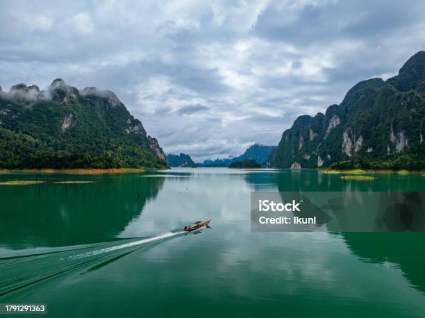 Aerial Drone View Of Tourist Boat On The Lake Of Tropical Mountain Peak Khao Sok National Park Thailand Stock Photo - Download Image Now