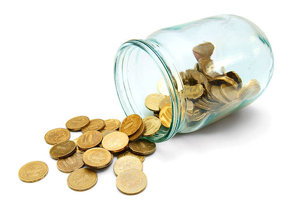 istock Glass and gold coins. On a white background. 179129704