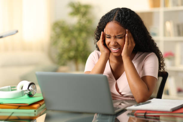 istock Black student suffering migraine studying at home 1791297742