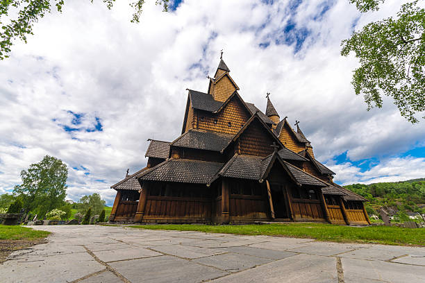 Stave Church at Heddal with Sky Dramatic sky above the stave church of Heddal in Norway. heddal stock pictures, royalty-free photos & images
