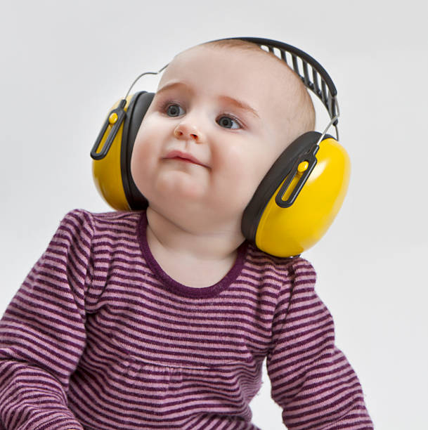 baby with ear protection stock photo