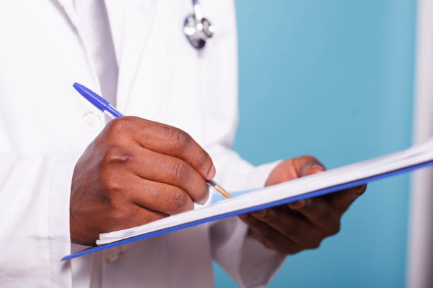 istock Medical Specialist Writing On Clipboard 1791323750