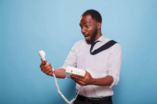 istock Stunned Worker Holding A Landline Phone 1791325343