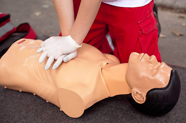 istock Man administrating CPR on a mannequin 179132589