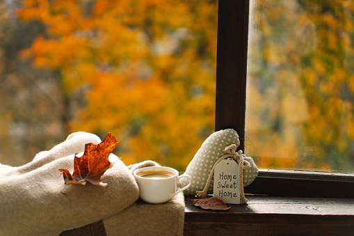 Sweet Home. Still life details in home on a wooden window. Hot coffee and autumn decor. Autumn home decor. Cozy fall mood. Cozy tea party. Template for design