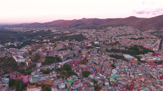 Mexico, Guanajuato: Aerial view of capital city of Mexican state of same name at sunset, typical buildings of many vibrant colors - landscape panorama of Latin America from above
