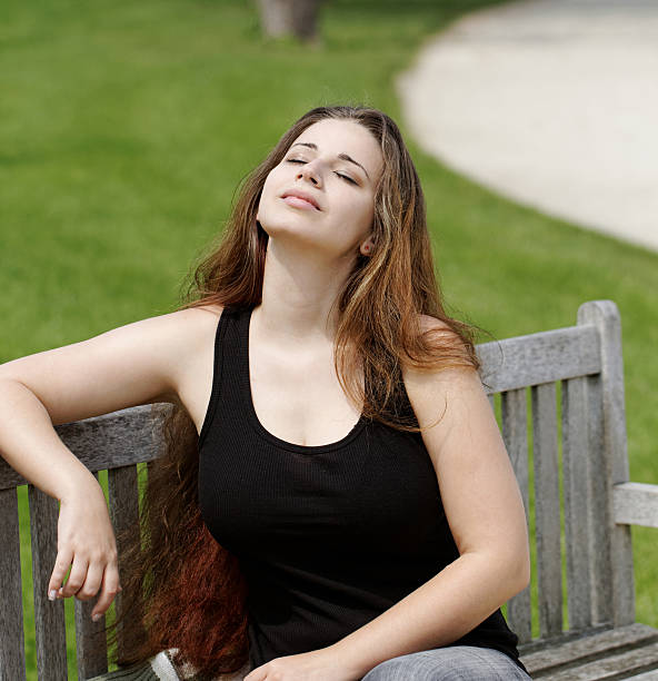 istock pretty young girl on a bench 179133488