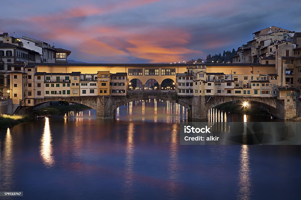 Ponte Vecchio stone bridge in Florence, Italy Famous Ponte Vecchio stone bridge over the Arno River in Florence, Italy. Ancient Stock Photo