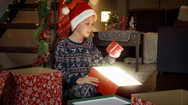 istock Cheerful smiling boy looking at beautiful mug he got as Christmas present from Santa 1791338020
