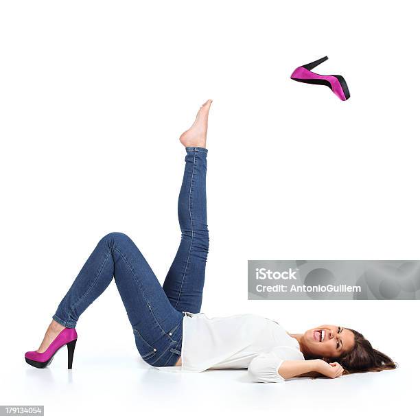 Attractive Woman With Jeans Throwing A Fuchsia Heel Stock Photo - Download Image Now