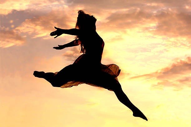 istock Woman Leaping at Sunset 179134417