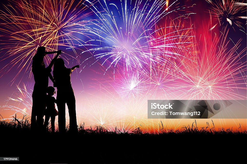 happy family  watching the fireworks happy family standing on the hill and watching the fireworks Firework Display Stock Photo