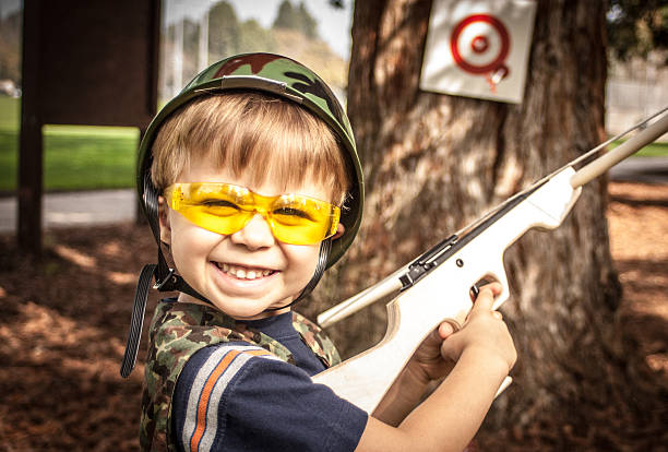 istock Boy Playing with Toy Crossbow Gun 179134759
