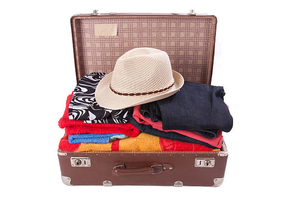 istock Vintage suitcase overstuffed with a summer hat 179135043