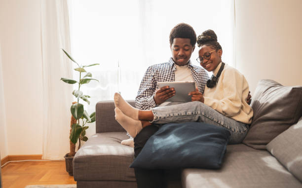 istock Couple sitting at home and using digital tablet 1791359478