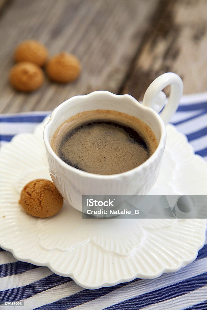 Espresso coffee cup with amarettini Espresso coffee cup with amaretti biscuits on wooden table Almond Stock Photo