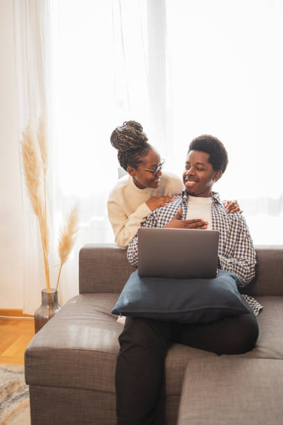 istock Happy couple sitting at home and using a laptop 1791360522