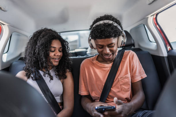 istock Siblings using mobile phone inside of the car 1791360547