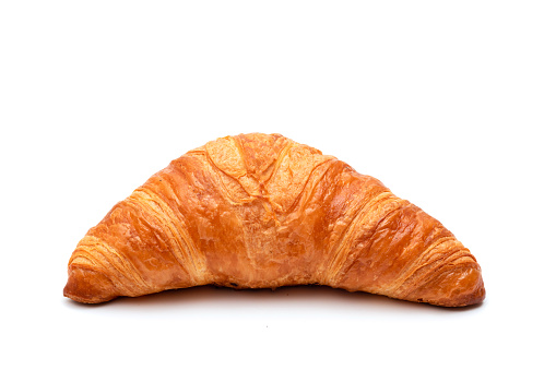 Crispy traditional croissant on a white background. Homemade baking.