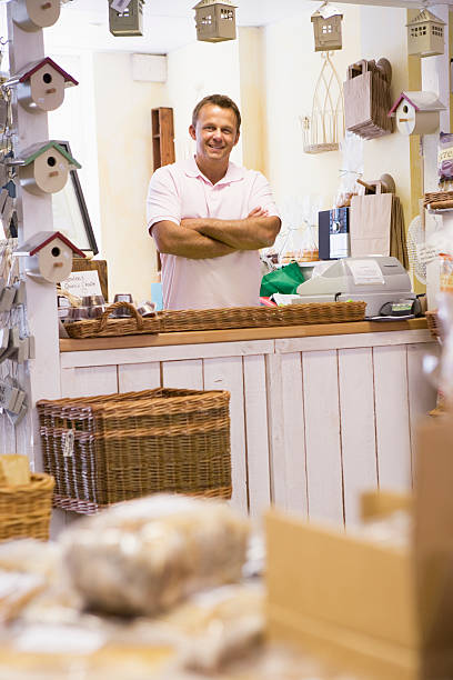 istock Man in birdhouse store smiling 179136763