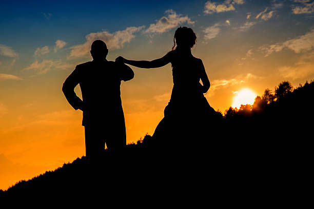 istock Couple standing with amazing sunset in backdrop 179136902