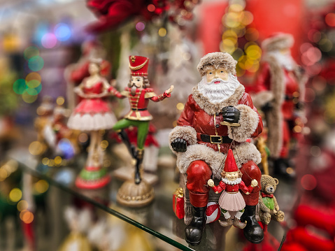 Close up color image depicting Santa Claus ornaments on display and for sale in the store at Christmas.