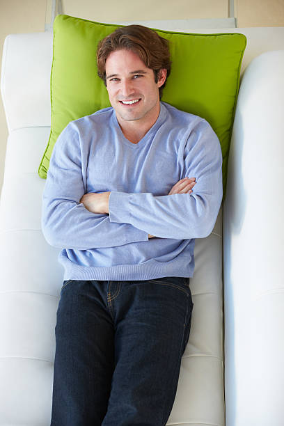 istock Overhead View Of Man Relaxing On Sofa 179137740