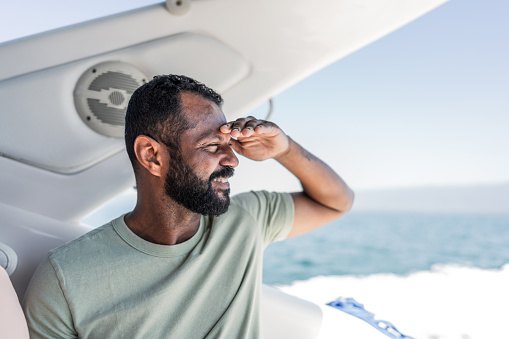 Mature man looking at view inside of speedboat
