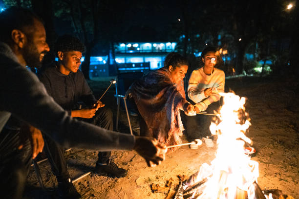 istock Family talking and roasting marshmallows around the campfire 1791382418
