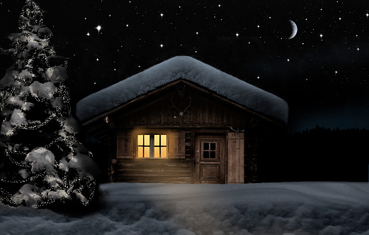 Snow-covered hut with christmas tree