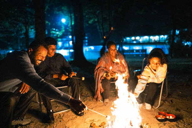 istock Family talking and roasting marshmallows around the campfire 1791383003