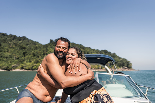 Mature couple embracing on a speedboat ride