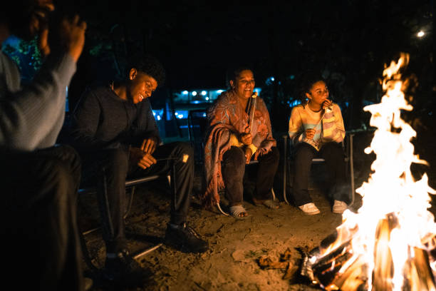 istock Family talking and roasting marshmallows around the campfire 1791383011
