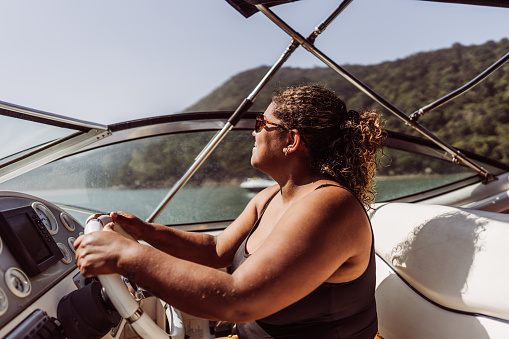 Mature woman driving speedboat