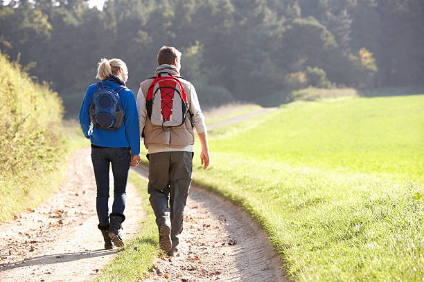istock Young couple walking in park 179138740