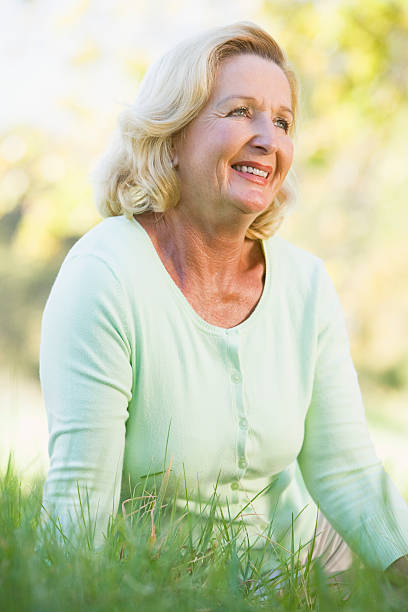istock Woman sitting outdoors smiling 179138963