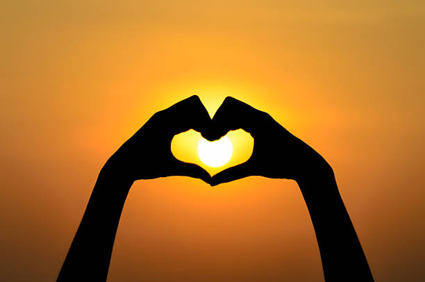 istock Love shape hands silhouette at sunset 179139135