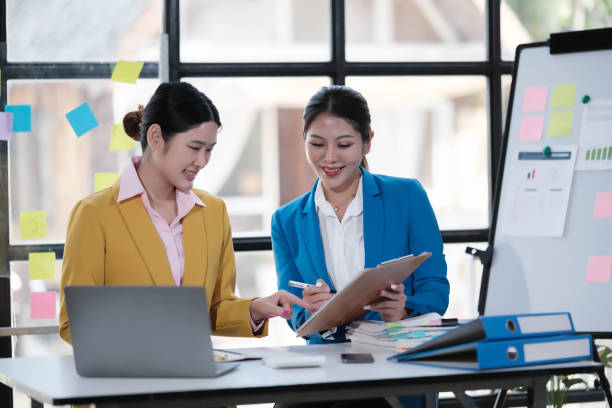 istock Two Young Asian businesswoman discuss with new startup project Idea presentation, analyze planning and financial statistics and investment market at office. 1791397719