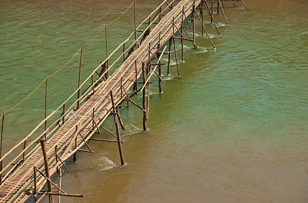 Bamboo bridge accross a river. stock photo