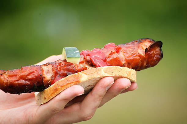 istock Sausage in hand nature barbecue 179140503