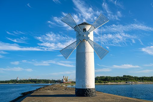 A view of the windmill in Swinoujscie on the Baltic Sea under a blue sky