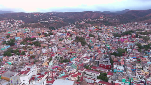 Mexico, Guanajuato: Aerial view of capital city of Mexican state of same name at sunset, typical buildings of many vibrant colors - landscape panorama of Latin America from above
