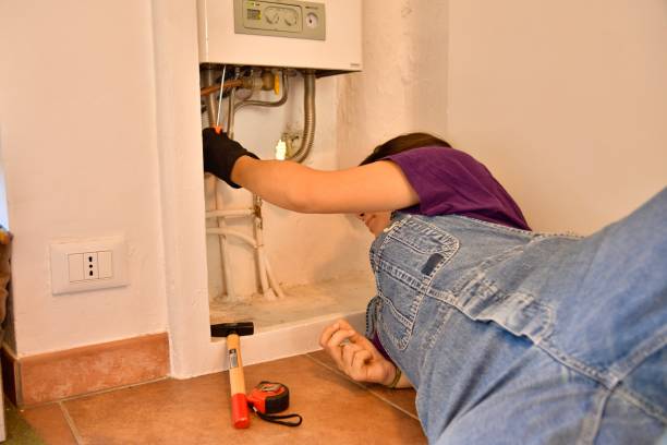 istock Young female technician repairs boiler 1791409952