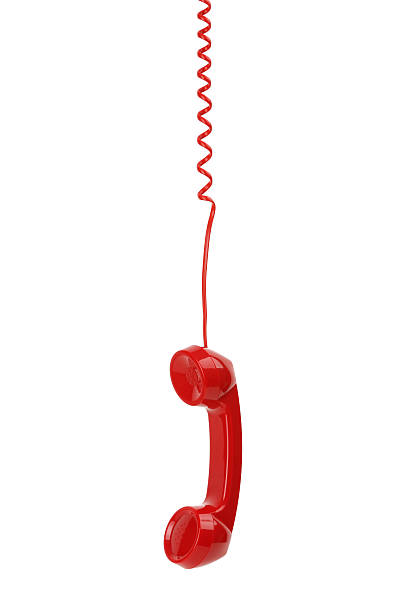 istock Red telephone receiver hanging down against white background 179141496